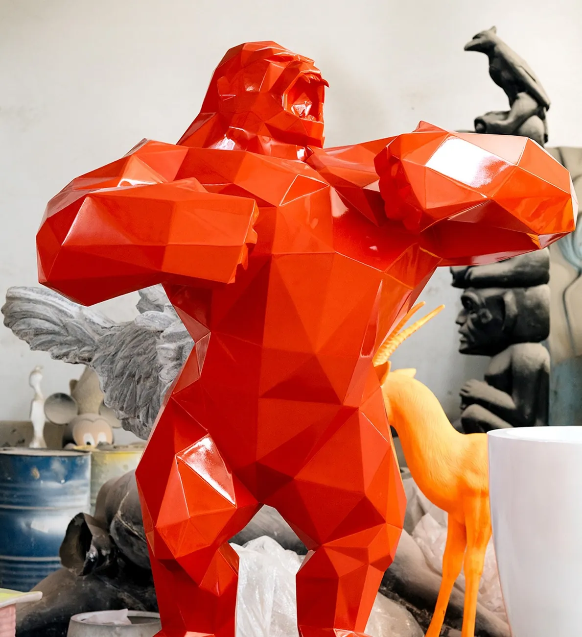 Red faceted gorilla sculpture in the workshop